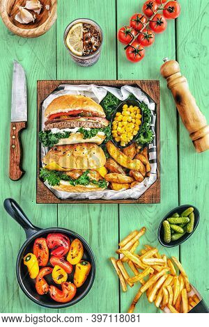 2 Ham Burgers Burgers On Square Box With Potato French Fries And Spices On White Table