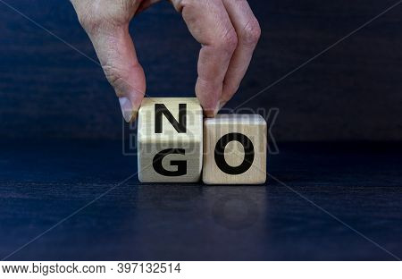 No Or Go. Hand Flips A Cube And Changes The Word 'no' To 'go'. Beautiful Grey Background. Business A