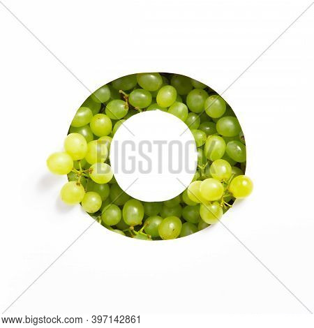 Letter O Of English Alphabet Of Fresh Grape And Cut Paper Isolated On White. Typeface Of Green Berri