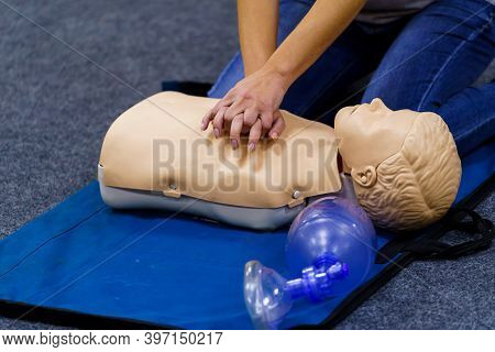 Demonstrating Chest Compressions. Medical Doll Is The Simulator For Training In First Aid. Heart Mas