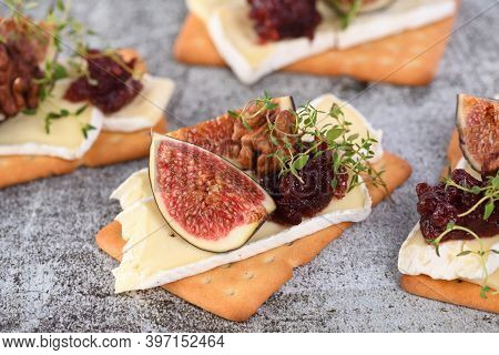 Cracker With A Slice Of Camembert, Jam, Figs And Nuts.
A Great Snack Idea For A Holiday, Picnic Or P
