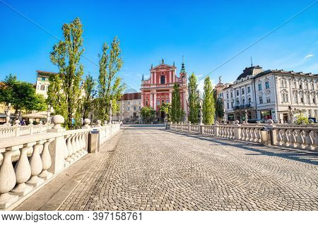 Ljubljana City Center During A Sunny Day Overlooking The Triple Bridge And Beautiful Franciscan Chur