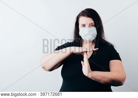 Confident Woman In Medical Mask Showing T Sign With Hands. Quarantine Restrictions, Time Out, End Co