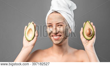 Funny Portrait Of Pretty Woman In A Towel On The Head With A Smile Holding Avocado Heaving Face Clay