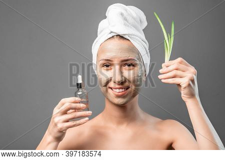 Beautiful Young Woman With Plant Aloe Vera, Serum. Moisturizing Natural Mask On Face And Fresh Aloe 