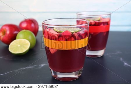 Closeup Chilled Red Wine Sangria On The Table With Blurry Fresh Fruits In The Background