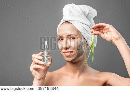Beautiful Young Woman With Facial Mask Containing Aloe Vera Extract, Care. Cleansing Procedure. Cosm