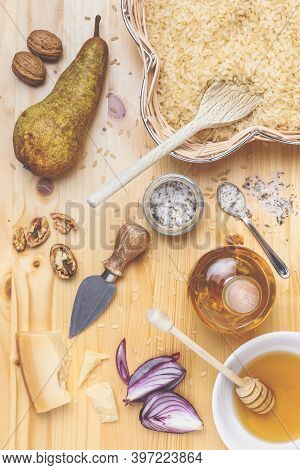 Assorted Ingredients For Cooking Rice. Raw Carnaroli Rice, Pears, Walnuts, Honey, Onions, Parmesan A