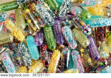 Closeup of glittery shimmery shiny pills capsule background 