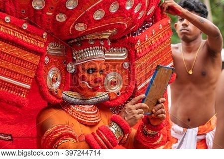 Payyanur, India - December 3, 2019: Theyyam artist perform during temple festival in Payyanur, Kerala, India. Theyyam is a popular ritual form of worship in Kerala, India