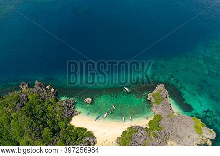 Aerial View Of Small Isolated Tropical Island With White Sandy Beach And Blue Transparent Water And 