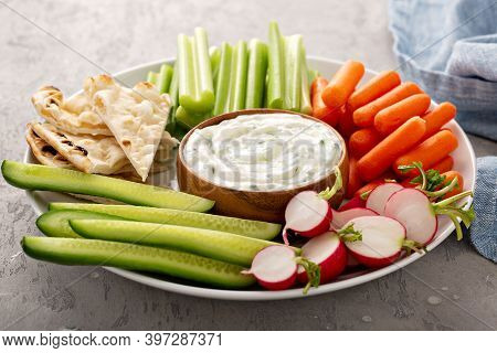 Large Snack Board With Tzatziki Dip Made With Yogurt And Cucumber With Fresh Vegetables And Pita