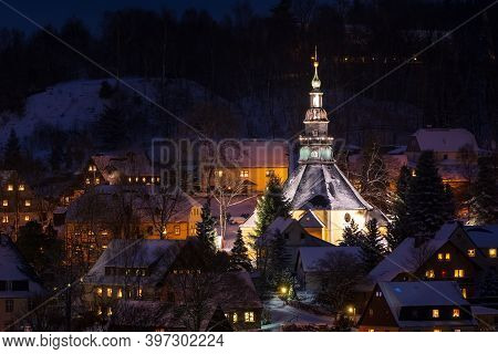 Illuminated Church In Seiffen At Christmastime. Saxony Germany