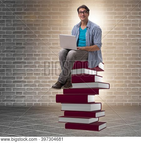 Young man in telelearning concept with laptop and books
