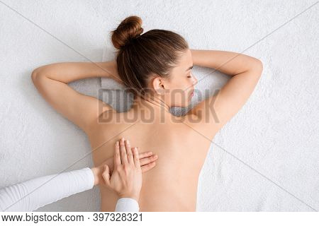 Top View Of Young Lady Having Healing Full Body Massage From Unrecognizable Female Therapist At Luxu