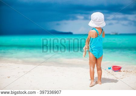 Adorable Little Girl Playing With Beach Toys On White Tropial Beach