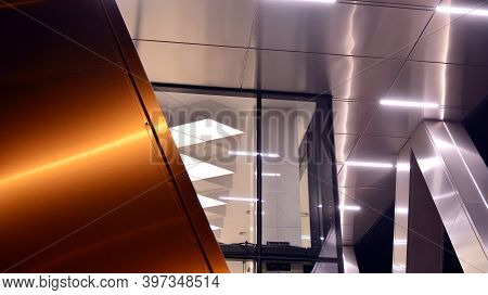 Combination Of Metal And Glass Wall Material. Steel Facade On Columns. Abstract Modern Architecture.