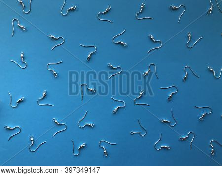 A Pattern Of Earring Hooks To Create Jewelry On A Blue Background. Basics For Earrings, Diy Jewelry.