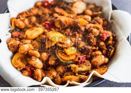 Plant-based Food, Vegan Pie With Mediterranean Vegetables Potato And Olive Red Pesto Before Going In