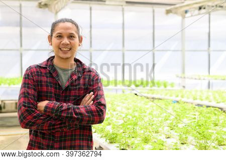 Portrait Of Youngman Asian Farmer Smile And Arms Crossed In Hydroponic Vegetables Farm