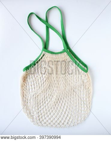 Empty Mesh Shopping Bag, White Net Cotton String With Green Holding Border On White Background. Tote