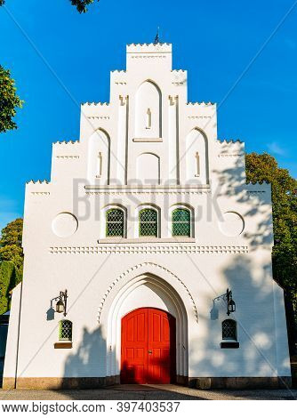Beautiful Chapel With White Chalk Walls And A Red Door.
