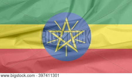 Fabric Flag Of Ethiopia. Crease Of Ethiopian Flag Background, Tricolor Of Green, Yellow And Red With