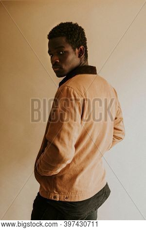 Brown short jacket mockup on African Amercan male model in the studio