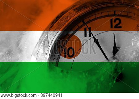 Niger, Nigerien Flag With Clock Close To Midnight In The Background. Happy New Year Concept