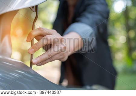 Close Up Hand Man Open Car Hood For Repair As Maintenance Service. Man Trying To Repair A Car Engine