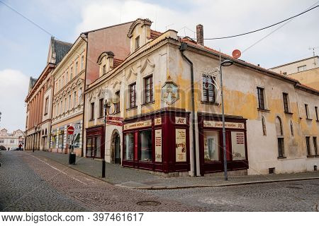 Narrow Picturesque Street With Colorful Buildings In Old Historic Center In Kolin, House With Three 