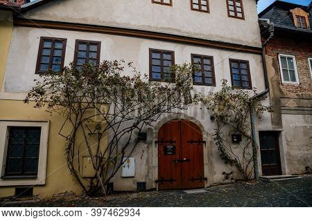 Narrow Picturesque Street With Colorful Buildings In Old Historic Center, Vintage Oval Wooden Doors 