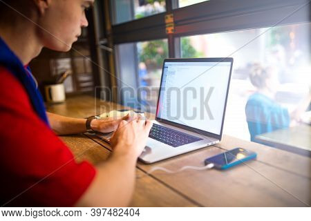 Man Skilled Website Content Creator Distance Working On Laptop Computer While Sitting In Coffee Shop