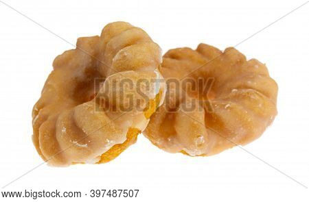 Side View Of Two Glazed Bite Size Crullers On A White Background.