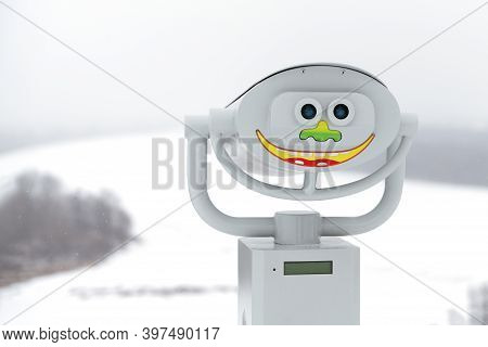 Viewing Binoculars With A Funny Face Pasted On The Background Of A Winter Landscape. Copy Space.