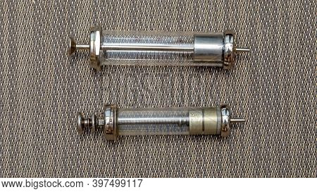 Two Big Old Reusable Glass Syringes Devices