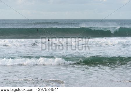 Surfers Surfing In Baleal Island Beach Atlantic Ocean Waves In Peniche, Portugal