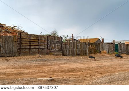 Houses In Kalmyk Village With A High Wooden Fence