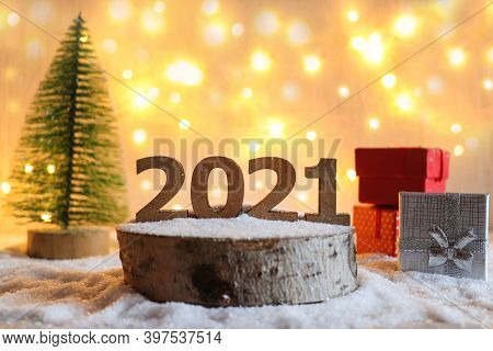 Beautiful New Year Greeting Card With Selective Focus. Numbers 2021 On Wooden Stand Against Festive 