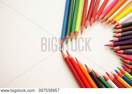 Colorful Wooden Pencils In The Shape Of A Heart On The Right, Isolated On White Background In The Sh
