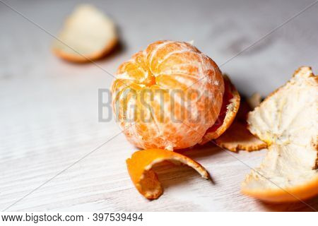 Peeled Ripe Juicy Mantarin On The Kitchen Table