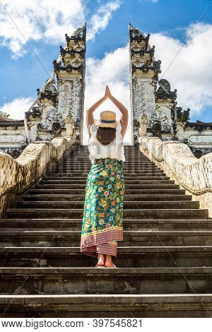 Woman Traveler At Ancient Gate At Pura Penataran Agung Lempuyang Temple On Bali, Indonesia