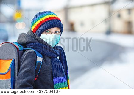 School Kid Boy With Glasses Wearing Medical Mask On The Way To School. Child Backpack Satchel. Schoo