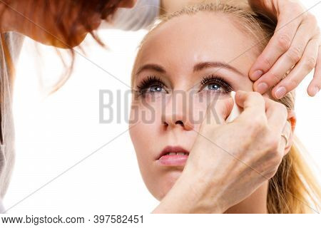 Two Women, Face Painting. Makeup Artist Applying Make Up To Model Face. Cosmetic Beauty Procedures, 