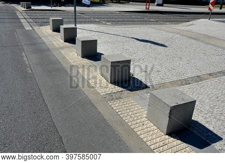 Concrete Barriers As Protection Of A Nice Lawn Cube Cubes On A Paved Sidewalk Platform Of A Tram Pro