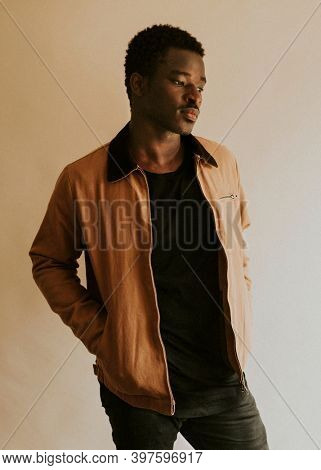 Brown short jacket mockup on African Amercan male model in studio
