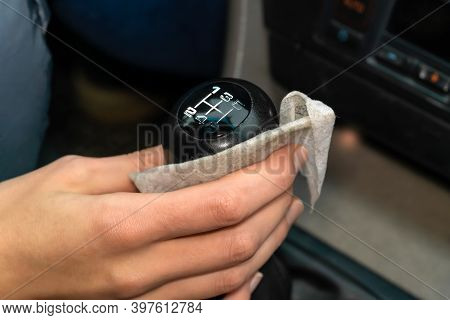 Womans Hand Wipes The Lever, The Car Selector With A Napkin Close-up. Dirty Napkin
