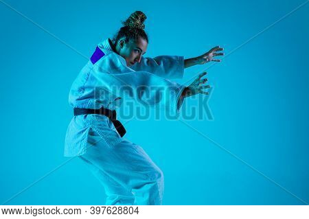 Active Training. Professional Female Judoist In White Judo Kimono Practicing And Training Isolated O