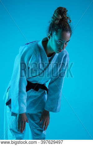 Tachi-rei. Professional Female Judoist In White Judo Kimono Practicing And Training Isolated On Blue