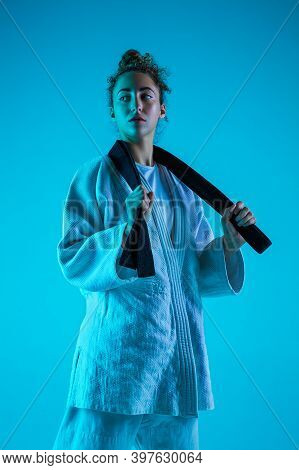 Take A Rest. Professional Female Judoist In White Judo Kimono Practicing And Training Isolated On Bl